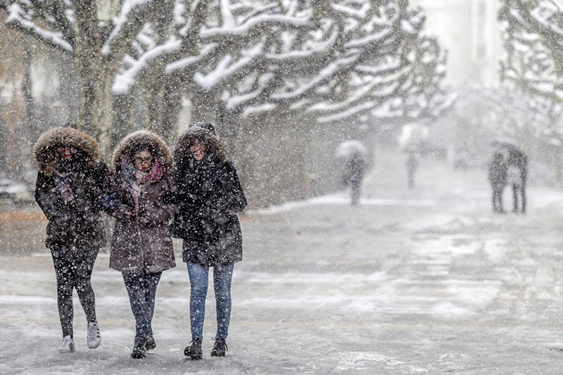 people walking in snowstorm
