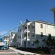 condo complex with cherry picker on roof