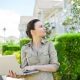 woman with laptop outside managed community