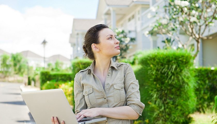 woman with laptop outside managed community